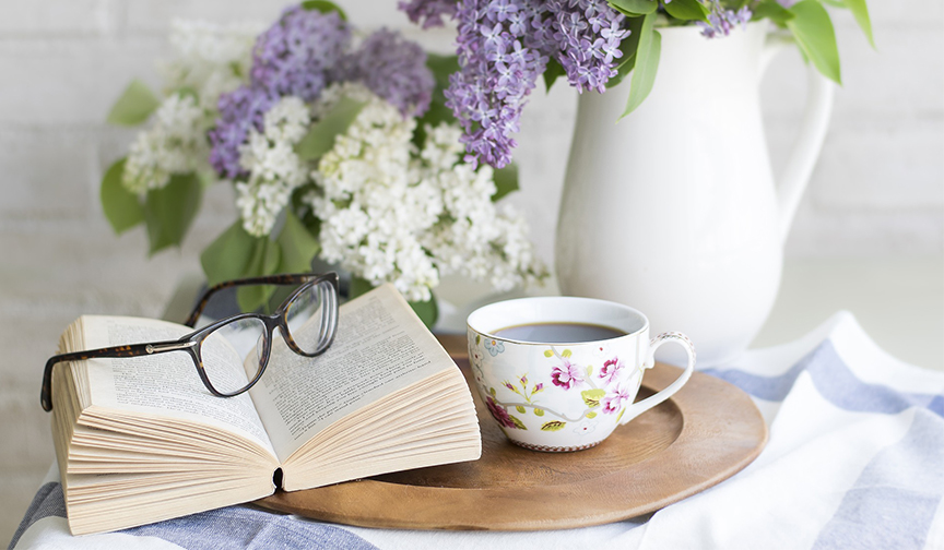 Start the day off with a few minutes of reading Book open with morning tea and flowers