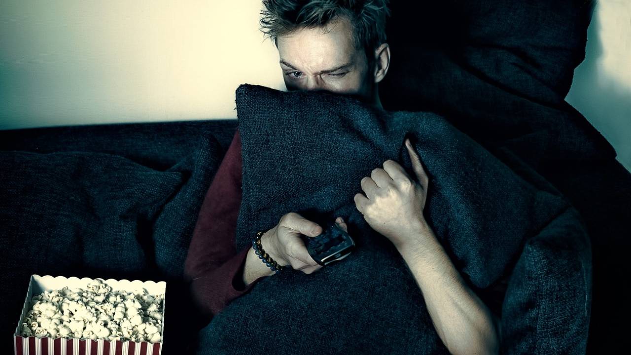 Leicester student watching horror film with popcorn