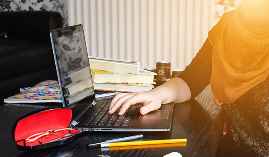 Leicester student using laptop to learn language