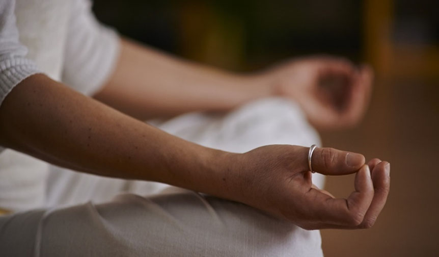 Guy meditiating in his student room