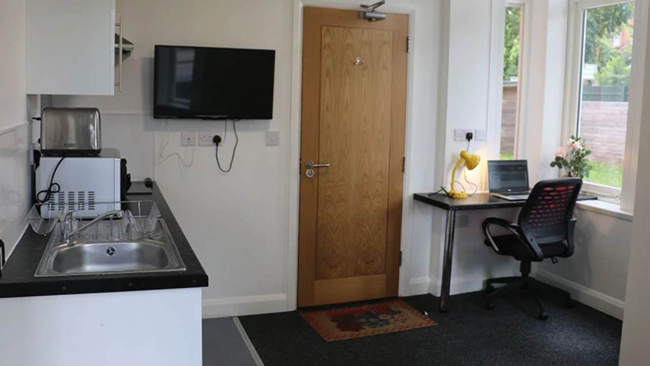 Student Accommodation in Leicester - Large seating area and TV on wall