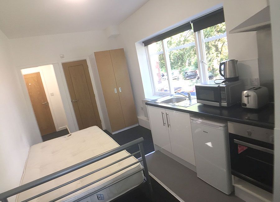 Regent Road Leicester Student Accommodation: Superior Studio - Large studio room with desk, kitchen and double bed side view